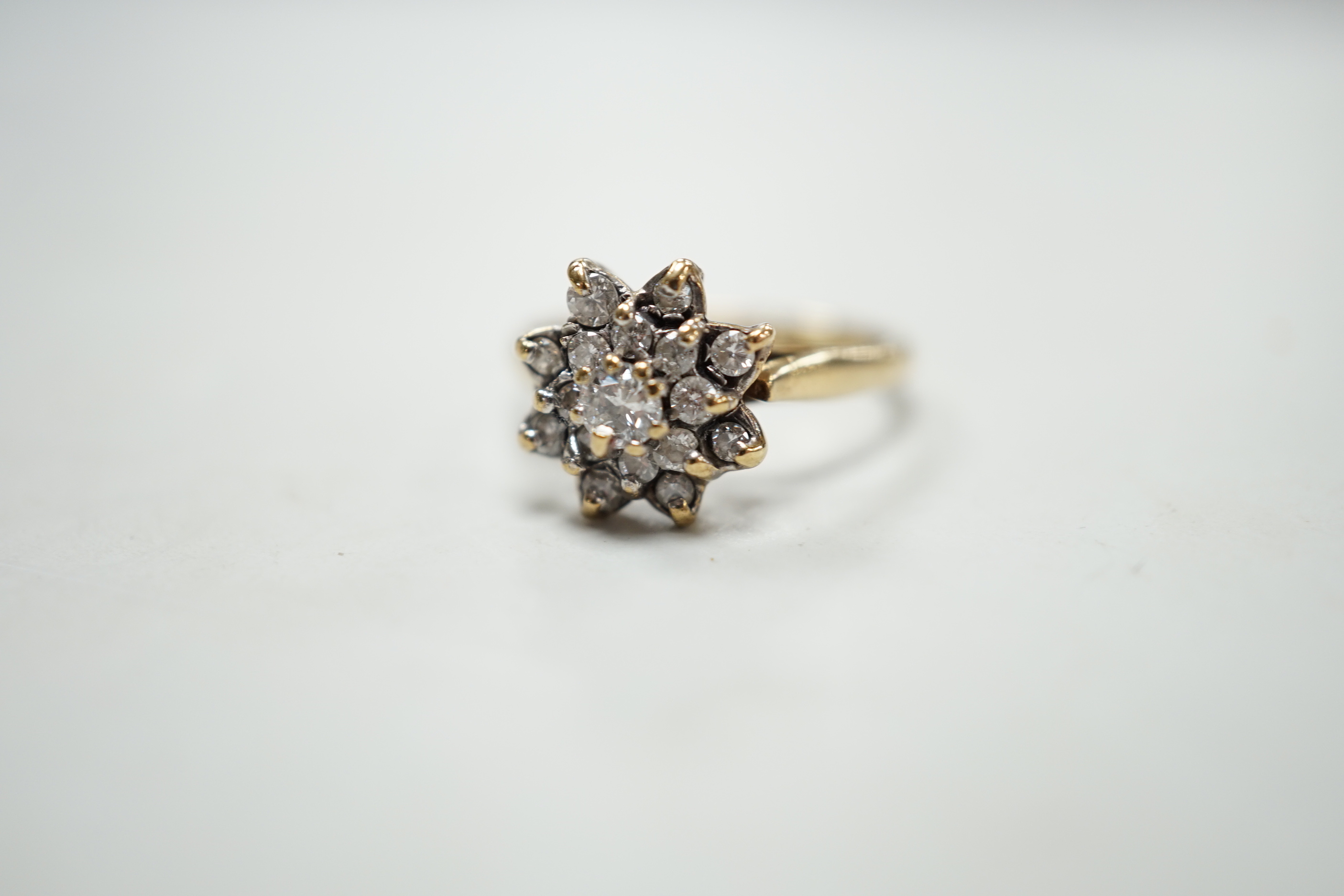 A modern 9ct gold and diamond cluster ring, size K/L, gross weight 3.1 grams.